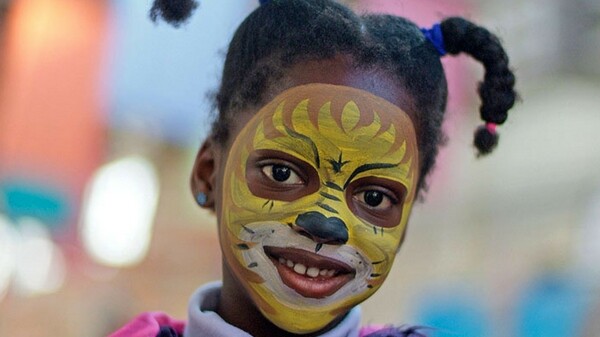 Young girl with her face painted at the Old Bus Depot markets theme event Kids in the Shed