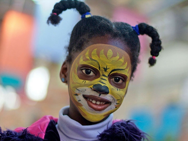 Young girl with her face painted at the Old Bus Depot markets theme event Kids in the Shed